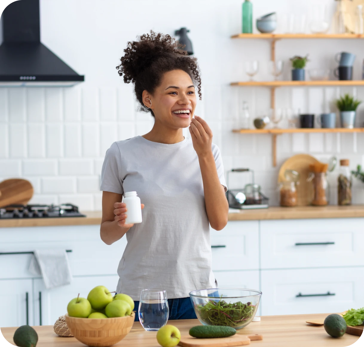 Happy woman in kitchen with fresh produce